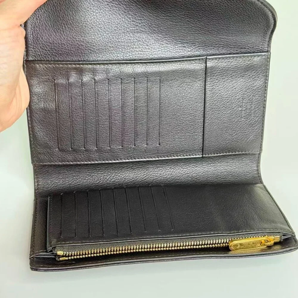 Louis Vuitton Black Monogram Canvas Wallet with Gold Hinge Detail Elegant Design